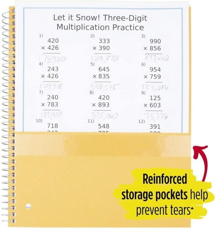 A fifth grader solving winter-themed three-digit multiplication problems with snowflake decorations on a worksheet