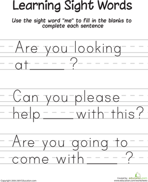 Kindergarten student completing a sentence with sight words on a printed worksheet