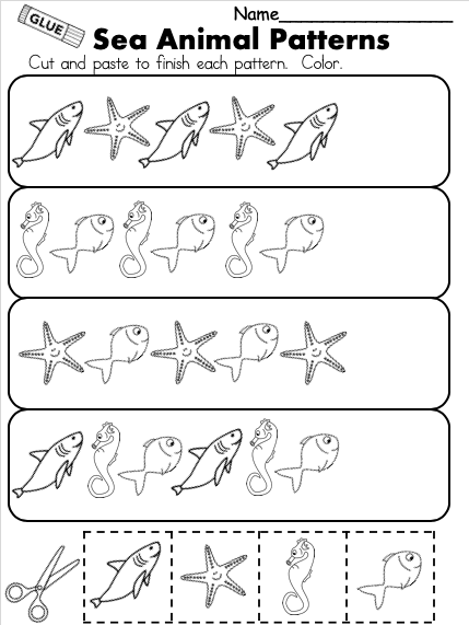 Cut-and-Paste Ocean Habitat Activity for Pre-K Students 19 Preschooler using safety scissors and glue to arrange ocean animal cutouts on a worksheet page