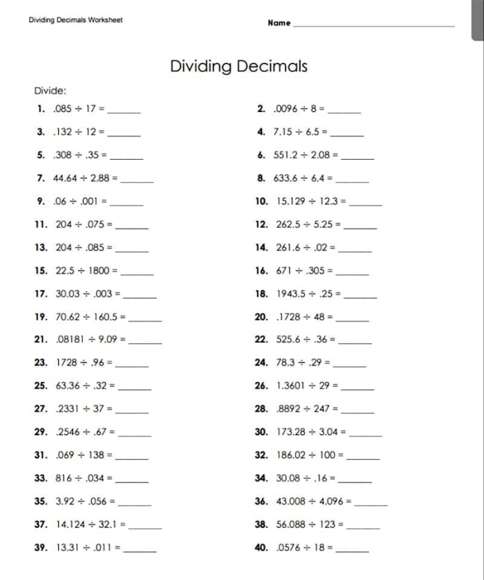Fifth grade math students working on a dividing decimals practice sheet