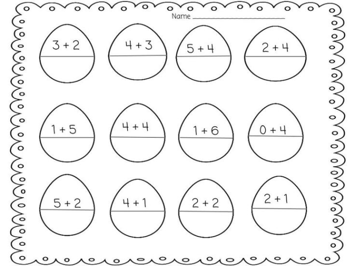Kindergarten students solving Easter addition problems using picture equations on a spring worksheet