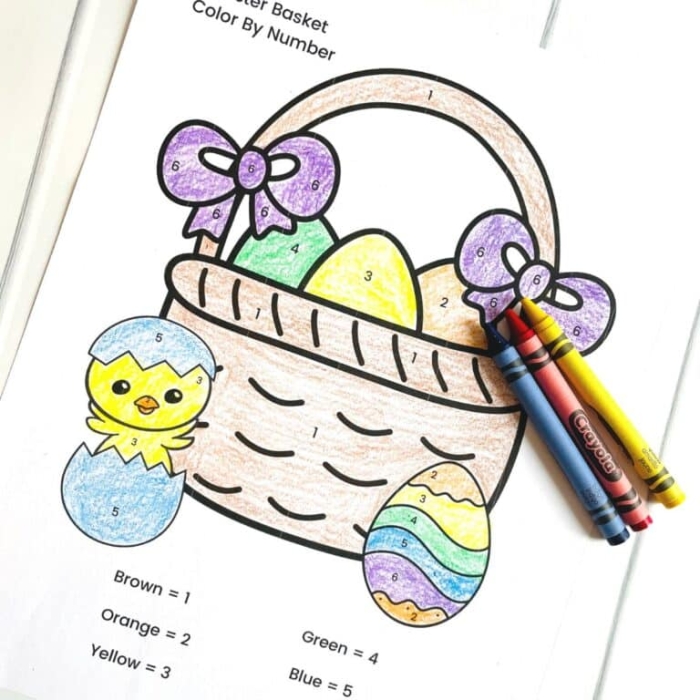 Kindergarten student coloring an Easter egg basket using the color by number worksheet 23