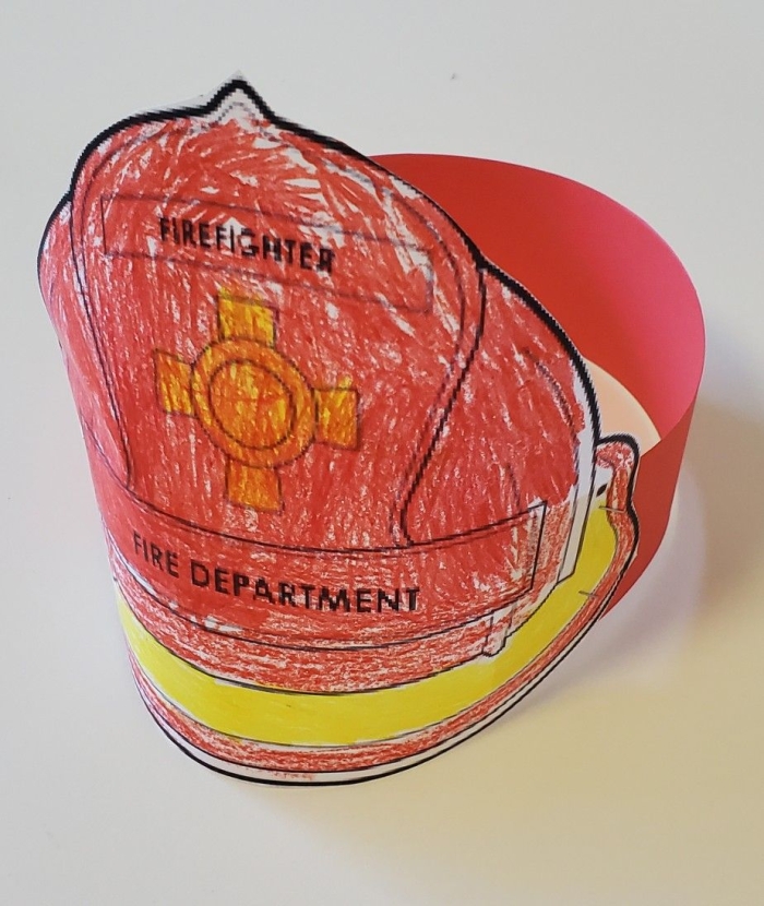 A coloring page of a firefighter hat for preschool students to decorate while learning about community helpers
