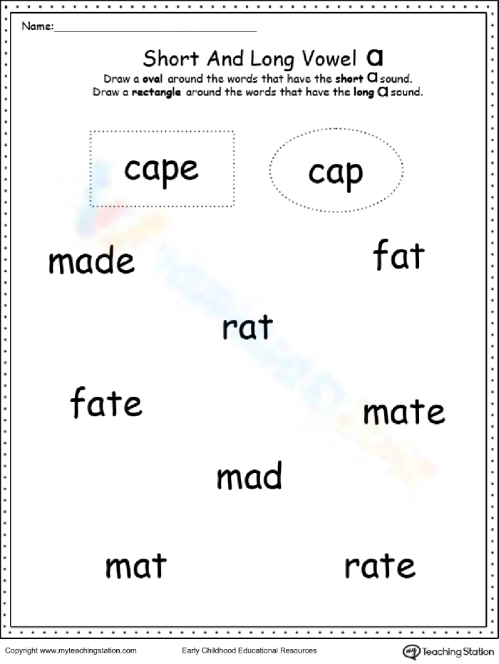 First grade student completing a cut and paste worksheet to sort short vowel sounds
