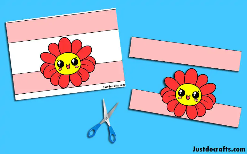 A first grade student holding a geometric flower crown craft for a spring worksheet activity