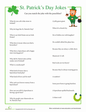 First grade students reading a fun St. Patrick's Day jokes worksheet with clover illustrations