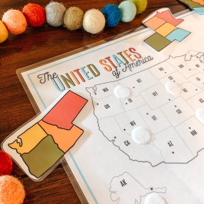 First grade student assembling a 50 U.S. states map puzzle worksheet