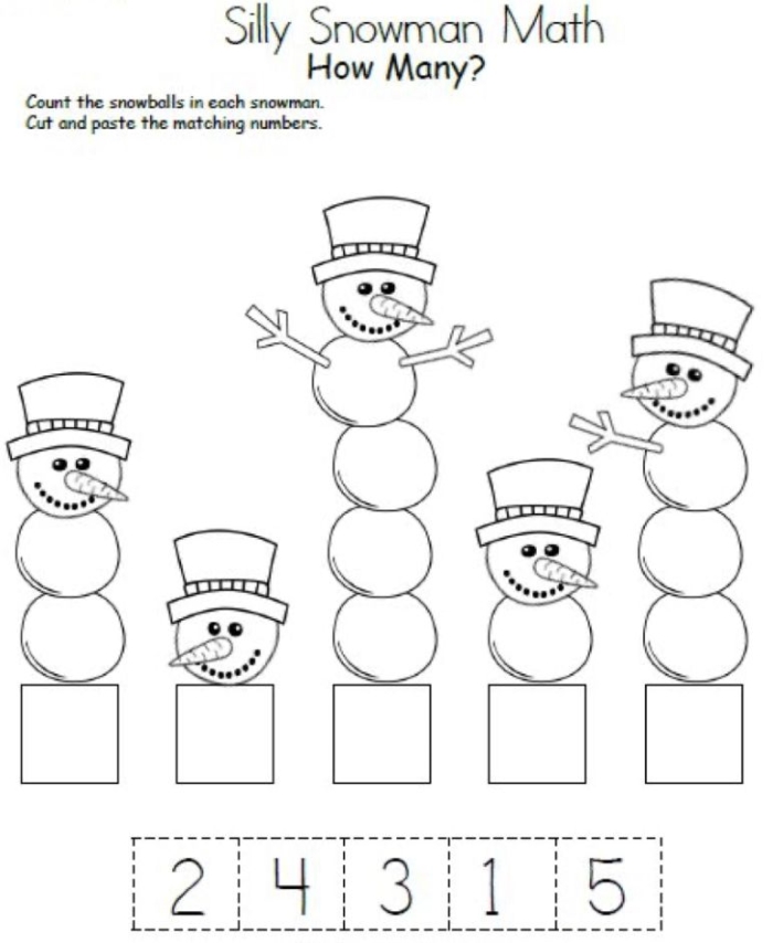 First grade student completing a winter themed single-digit addition math worksheet