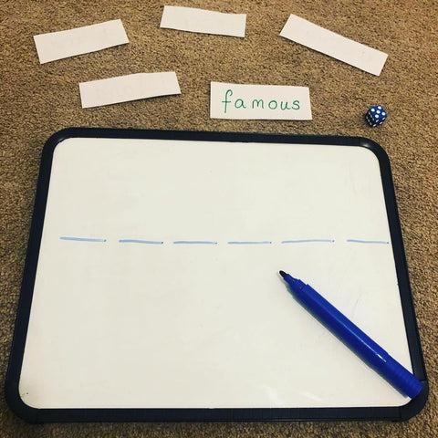 Colorful Roll a Word worksheet featuring dice and word family activities for first graders