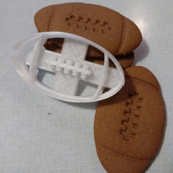 Worksheet for measuring football cookie lengths using fractional rulers in a fun way Football-themed measurement worksheet for third graders focusing on cookie sizes
