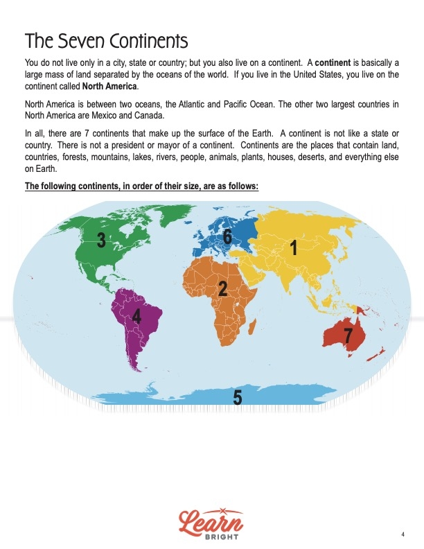 Fourth grade students cutting and pasting the seven continents onto a map for a geography activity