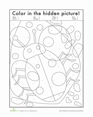 First grade student coloring a hidden bug by following number patterns on a worksheet