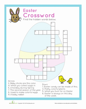 Kindergarten student filling out a colorful Easter crossword puzzle worksheet