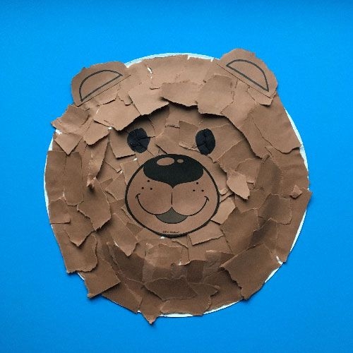 Kindergarten student reading a poem about a furry bear for a life science worksheet