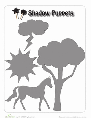 Kindergarten students engaging with a creative Halloween shadow puppets worksheet