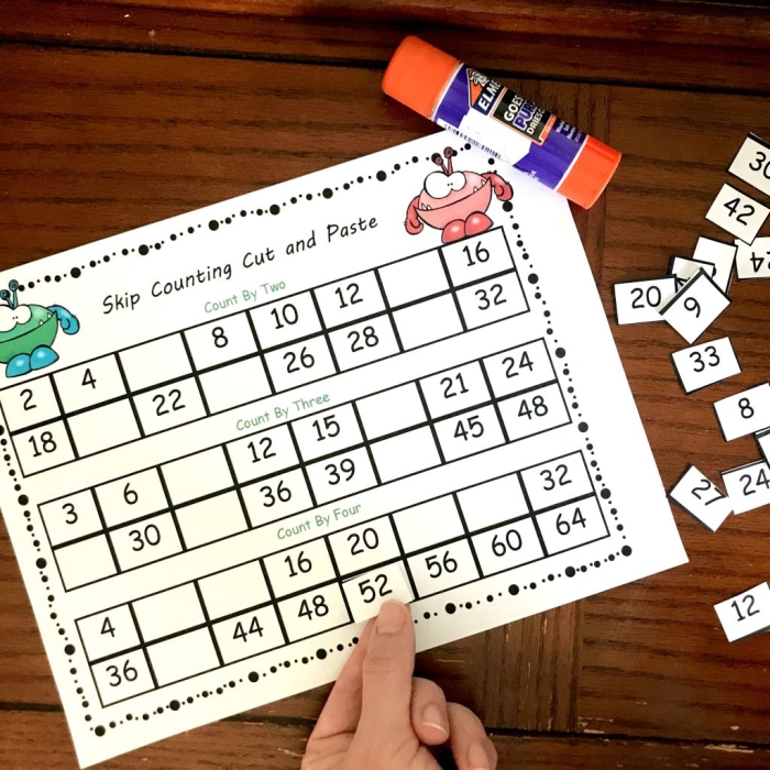 Kindergarten student completing a worksheet to fill in the missing numbers from 1 to 50