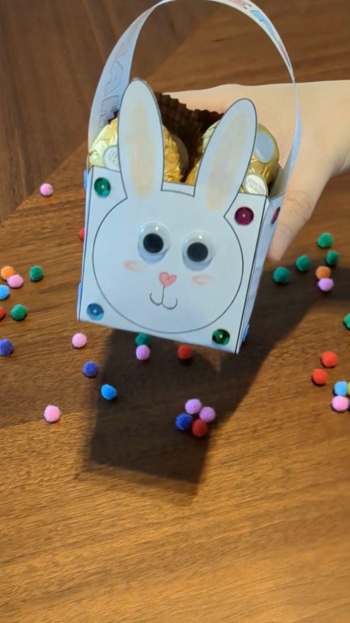 Printable paper Easter basket project for kindergarten reading activity 4 Kindergarten student folding paper to create a DIY mini Easter basket craft