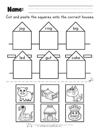 Kindergarten students cutting and pasting rhyming word pairs on a worksheet activity