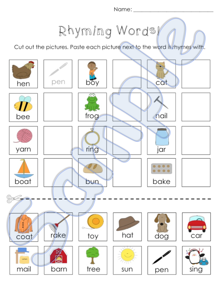 Kindergarten student cutting and pasting rhyming word pairs on a worksheet activity sheet