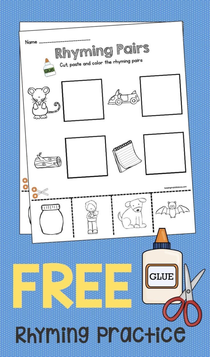 Kindergarten student cutting and pasting rhyming word pairs on a worksheet activity sheet