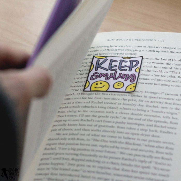 Kindergarten student writing colorful compliment notes with illustrations for friends, teachers, and family members as part of social emotional learning activity