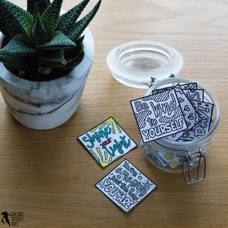 Kindergarten student writing and drawing compliment notes for friends, teachers, and family members as part of a social emotional learning activity