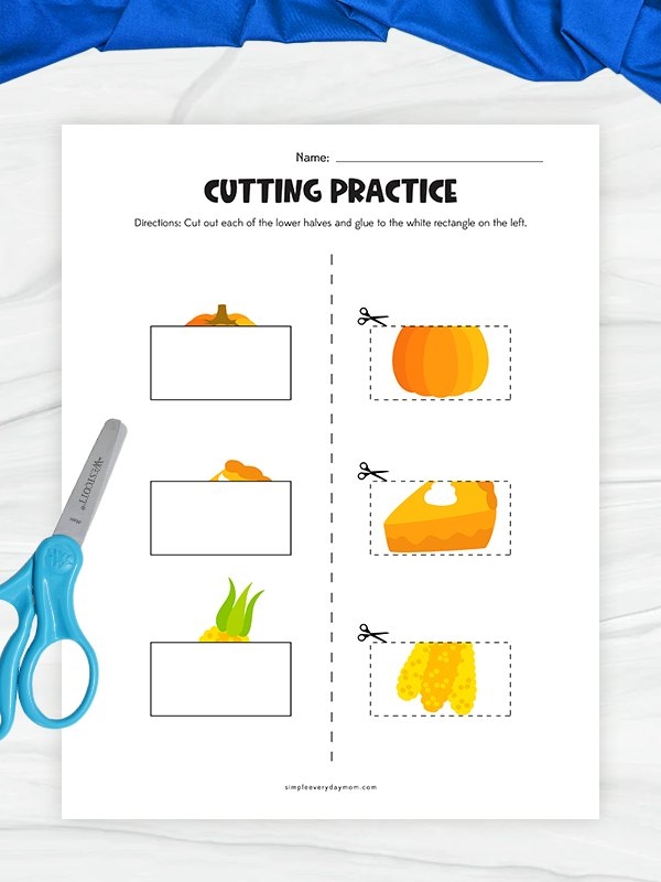 Kindergarten student crafting a funny turkey by cutting and pasting pilgrim clothing and body parts