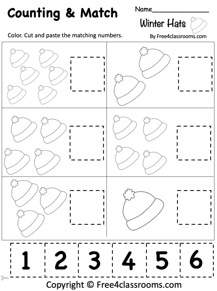 Kindergarten student completing a winter-themed addition math problem sheet