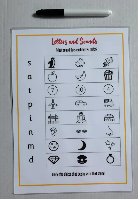 Kindergarten students hunting for hidden letter D shapes and dragonflies in a picnic scene worksheet