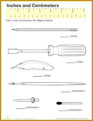 Second grade student using a ruler to measure colorful pencils in both centimeters and inches on a measurement worksheet