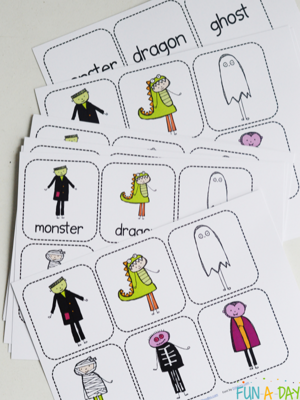 First grade students cutting out spooky monster cards for a memory matching game
