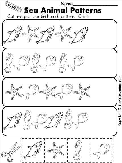 Kindergarten students solving ocean-themed addition problems with single-digit numbers and writing sums on a math worksheet