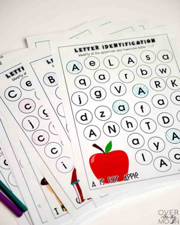 Pre-K student matching uppercase and lowercase letters on an alphabet review worksheet