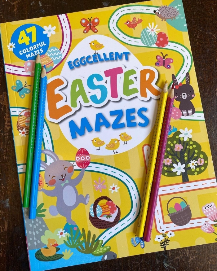 Pre-K student solving an Egg-cellent Maze worksheet featuring colorful Easter eggs
