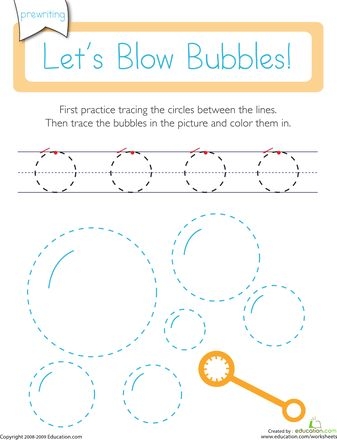 Pre-K student tracing circles and bubbles on a fine motor skill practice sheet