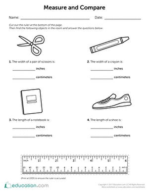 Second grade student using a paper ruler to measure objects in both inches and centimeters
