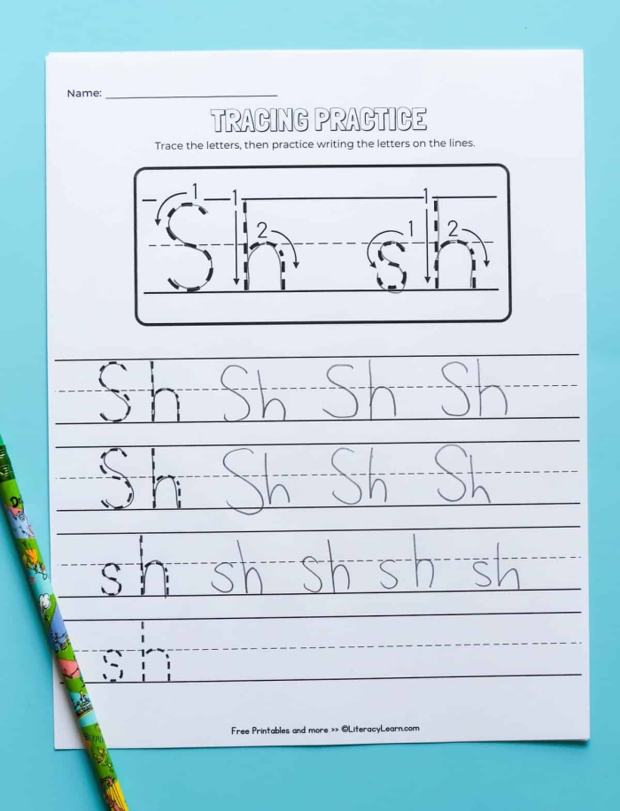 Preschooler completing a hands-on SH sound word recognition worksheet