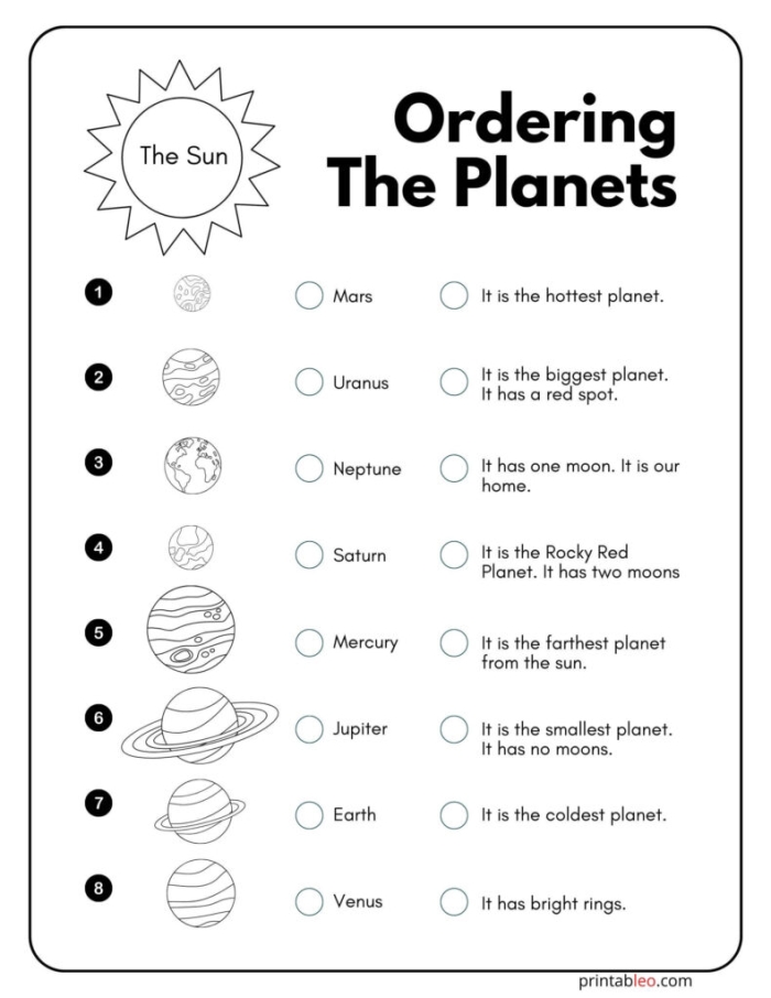 Second grade students matching planets and celestial bodies to solar system facts on a science worksheet