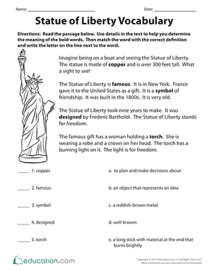 Third grade students completing a Statue of Liberty vocabulary worksheet with educational division exercises