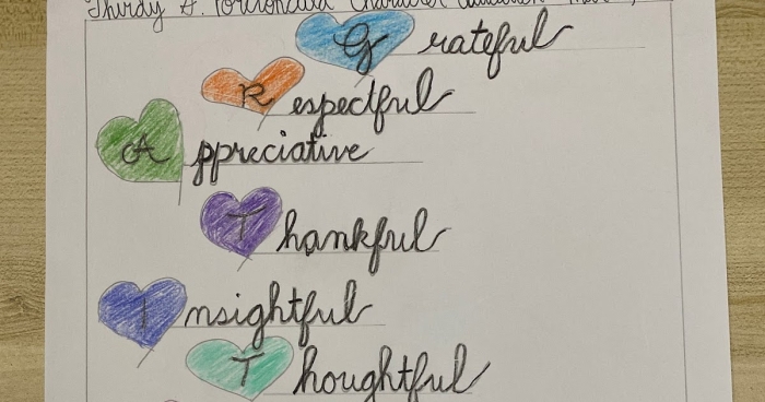 Write A Gratitude Acrostic Poem Practice Activity for Elementary Students Third grade student writing a gratitude acrostic poem on a worksheet with lines for each letter spelling out a thankful word