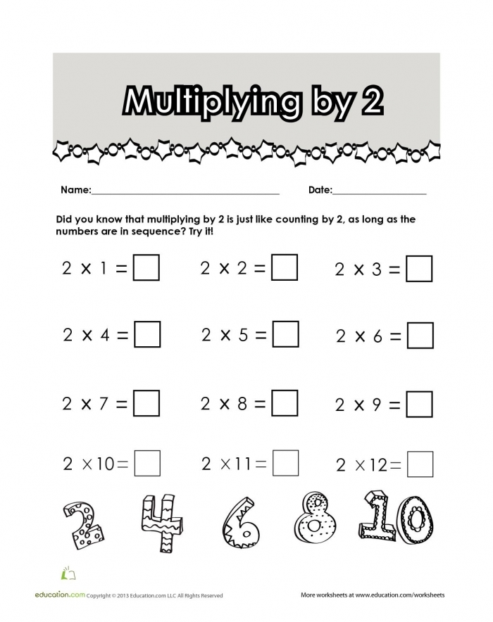 Third grade student completing a math worksheet on repeated groups for multiplication practice