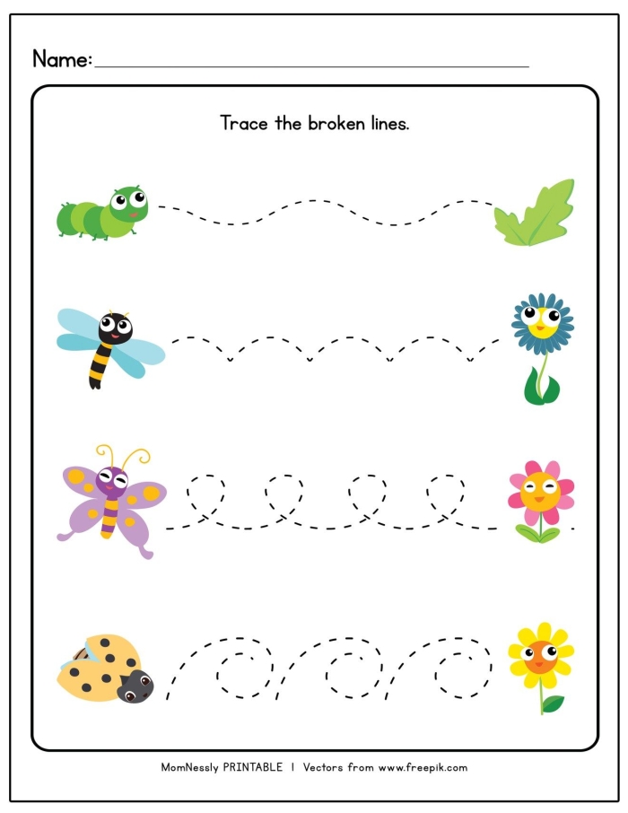 Children tracing lines connecting fall leaves to the ground in a pre-K worksheet