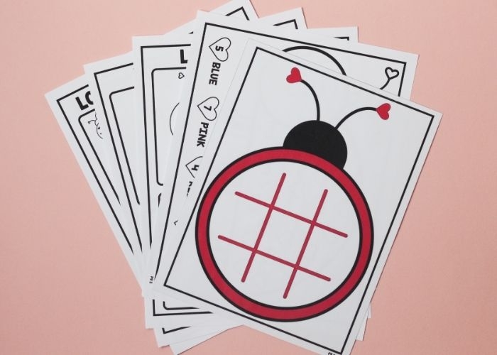 First grade Valentine's Day addition worksheet with kiss candies used as manipulatives to solve math problems