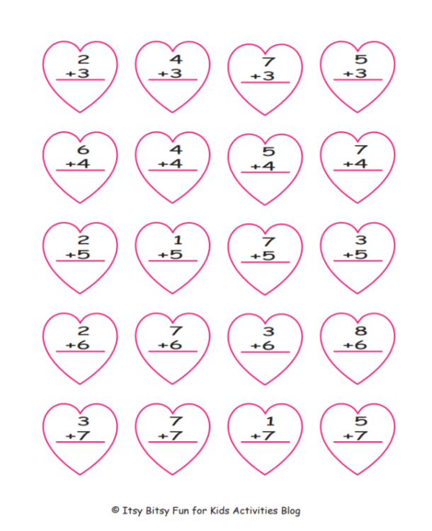 First grade student solving Valentine math addition problems with chocolate kiss counters