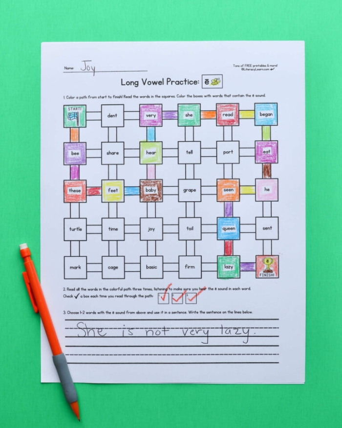 Preschooler circling long vowel words on a colorful worksheet for early reading
