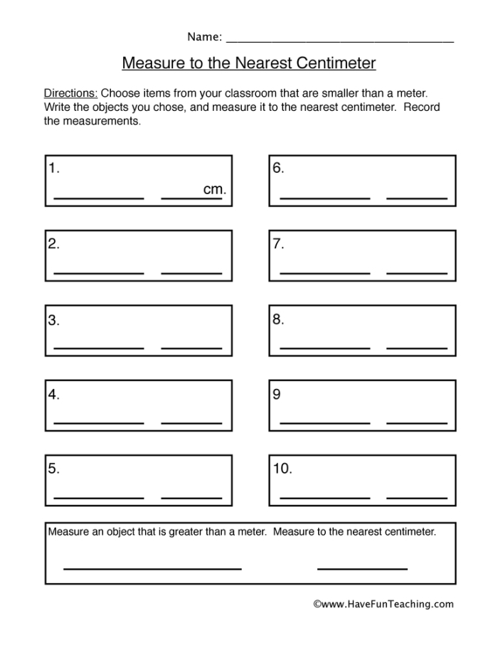 First grader measuring a sneaker in centimeters on a worksheet