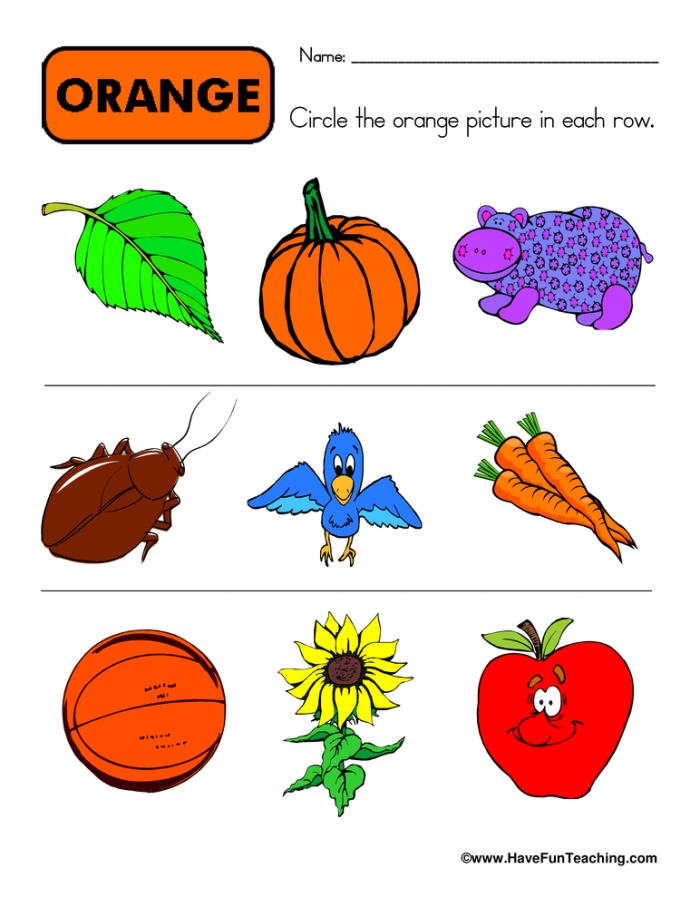Exploring the color orange with a creative worksheet for preschoolers Child coloring an orange page in a homemade color book for a fun learning activity