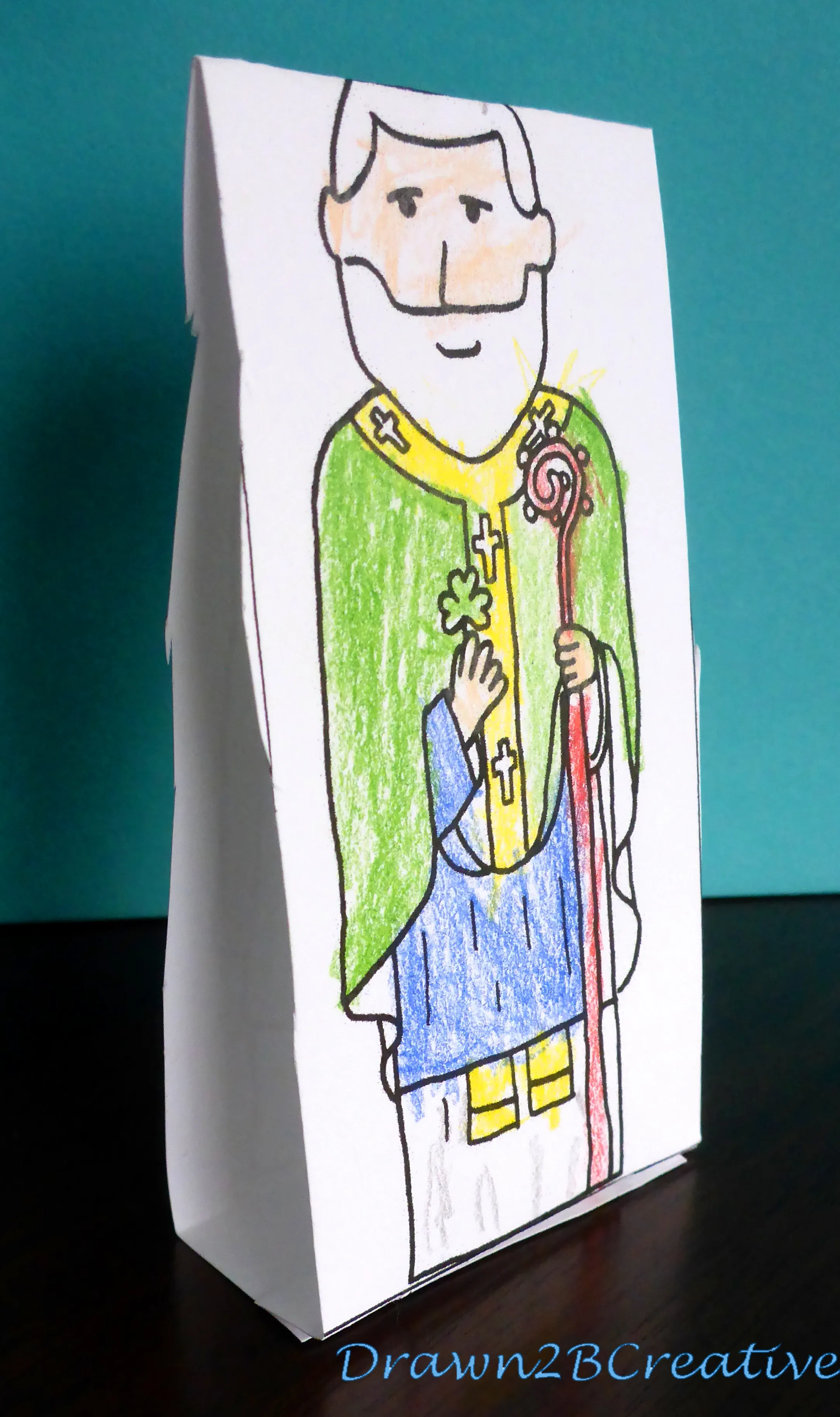 Pre-K girl paper doll dressed for St. Patrick's Day with colorful clothes and accessories