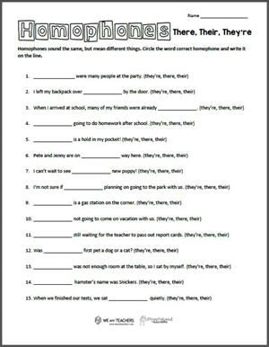Second grade students filling out a worksheet on homophones, focusing on they're and their