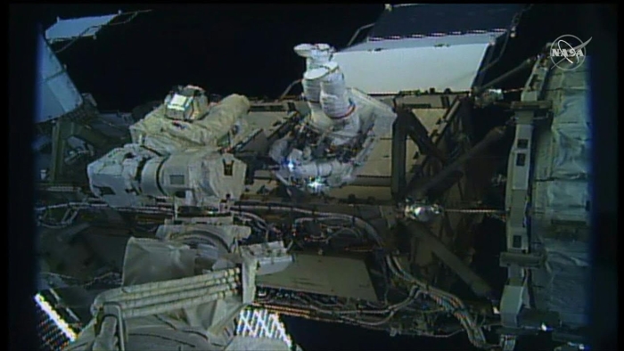 Worksheet on the landmark all-women spacewalk mission with Koch and Meir for young readers Two female astronauts performing a historic spacewalk outside the ISS for second graders